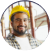 A construction worker wearing a hard hat and smiling.